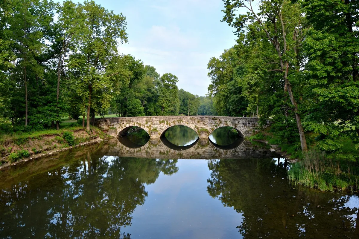 The Blanchard River flowing through tree-lined banks in Findlay, Ohio