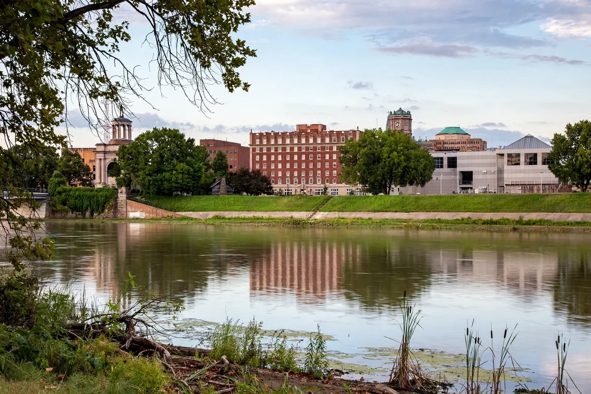 The Great Miami River flowing past historic brick buildings of downtown Hamilton Ohio