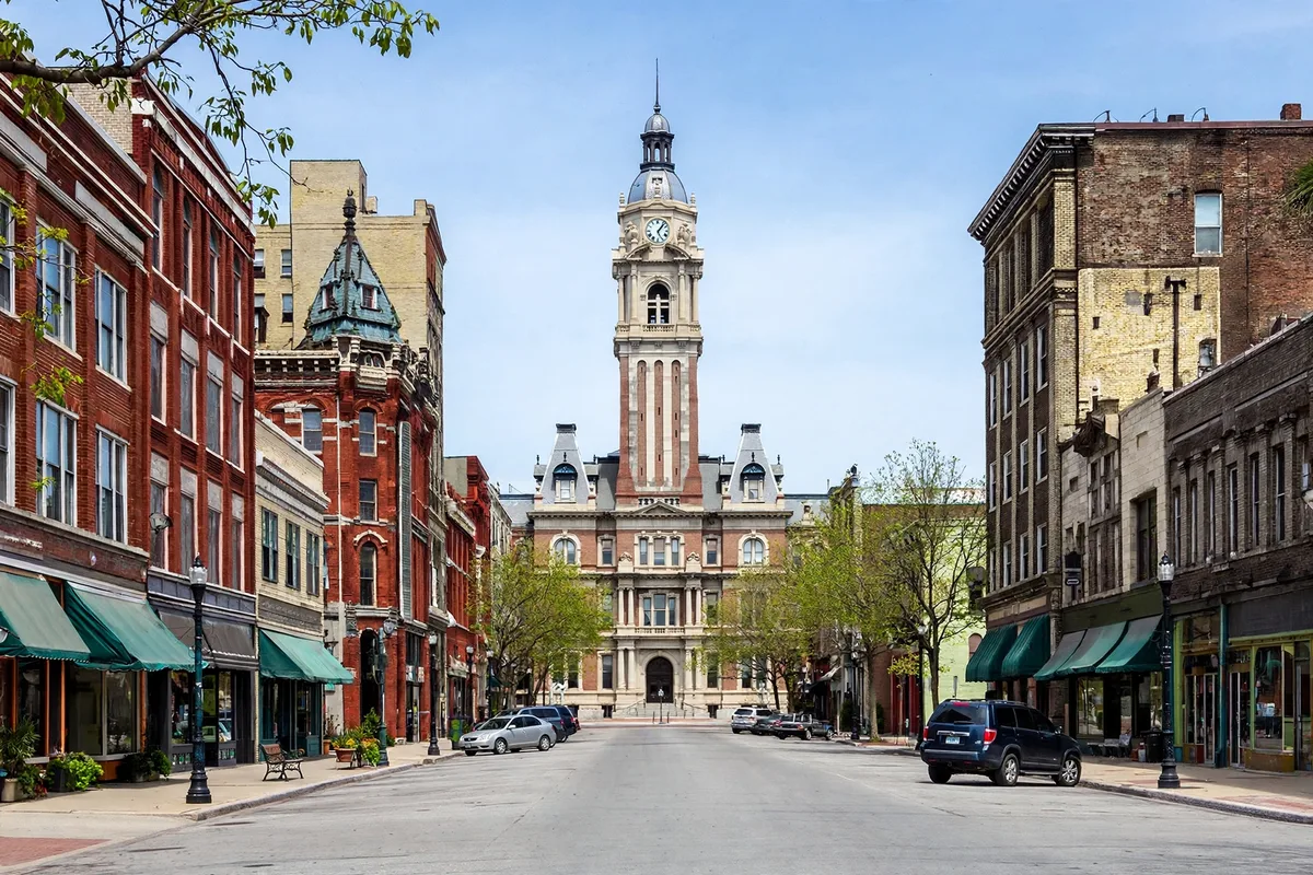 Historic brick buildings and a clock tower on a downtown main street in Lima, Ohio