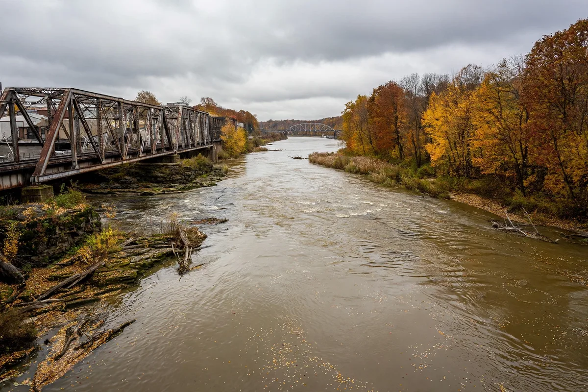 The Mahoning River flowing through Youngstown, Ohio, with historic steel bridges on an overcast autumn day